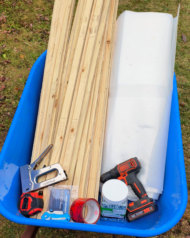 A wheelbarrow full of supplies to wrap a chicken run for winter.